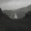 A foggy waterfall in a distance in a photo of the Iceland area in Lushfoil Photography SIM.