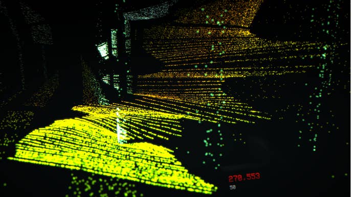 A hill and trunk is illuminated by a scanner