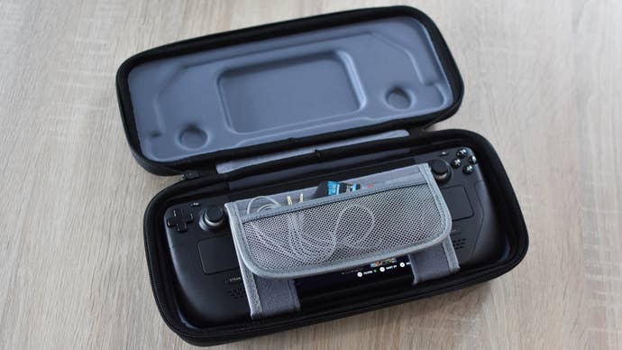 A steam floor inside the JSaux box. A headset cable and some microSD memory cards are put into a folding storage bag.
