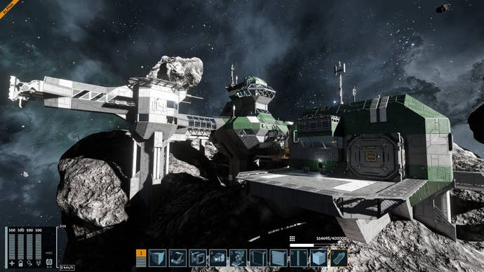 A green space station nestled into the rocks of a asteroid.